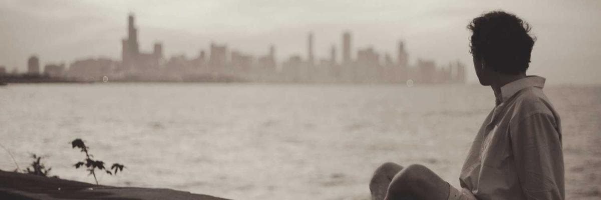 An open journal with a pen on a wooden table.