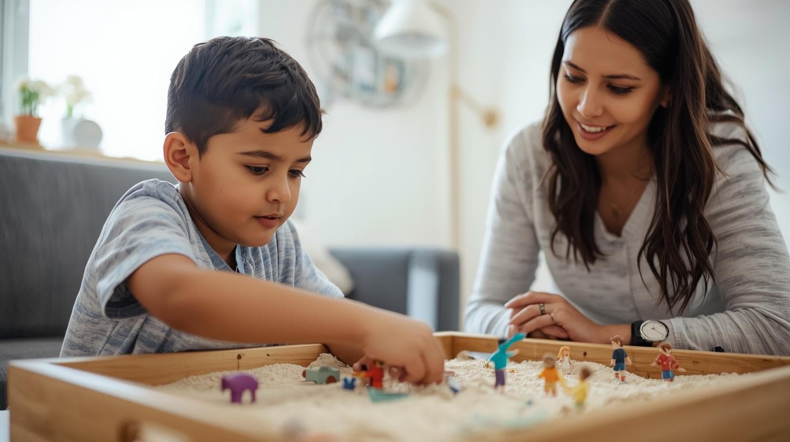 Colorful toys and a sandtray, indicating play therapy.